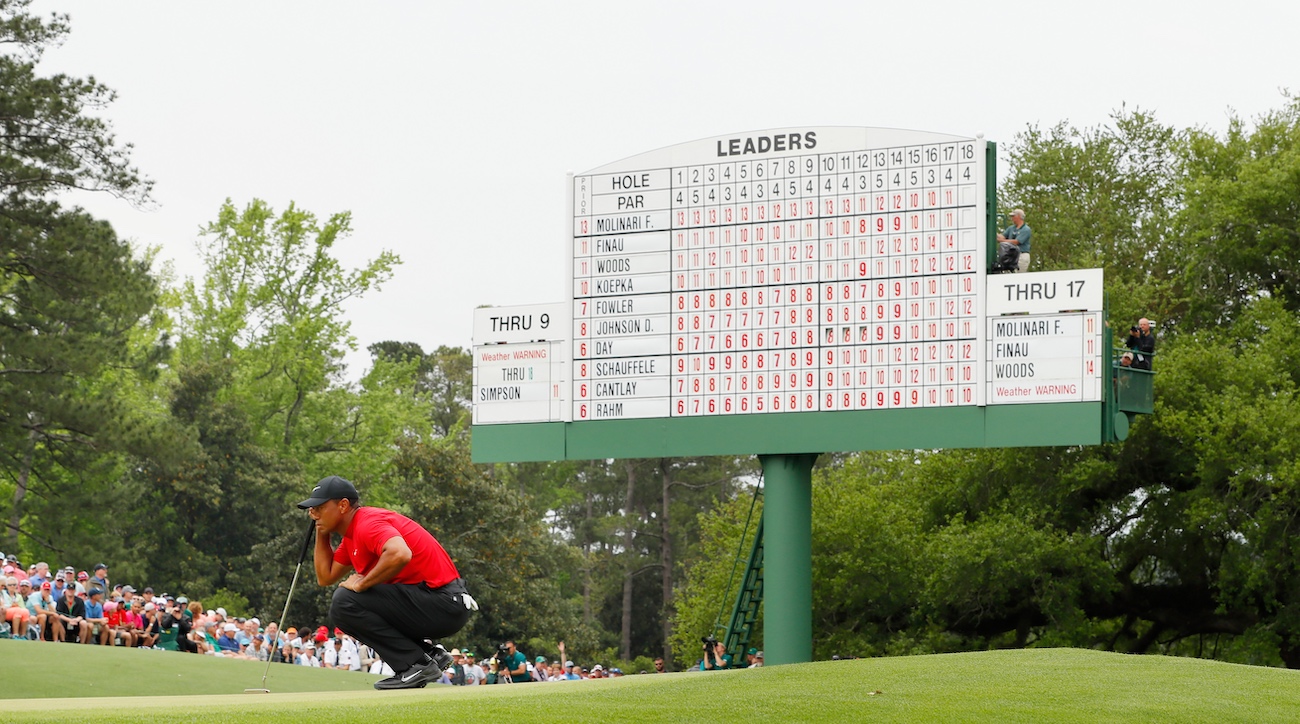 Tiger Woods surveys his putt on the 18th hole during the final round of the 2019 Masters.