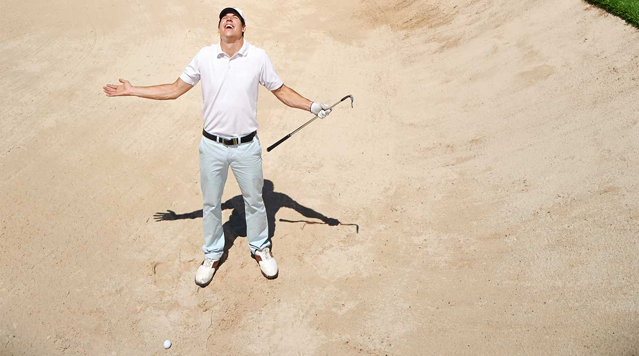 Man in golf course bunker.