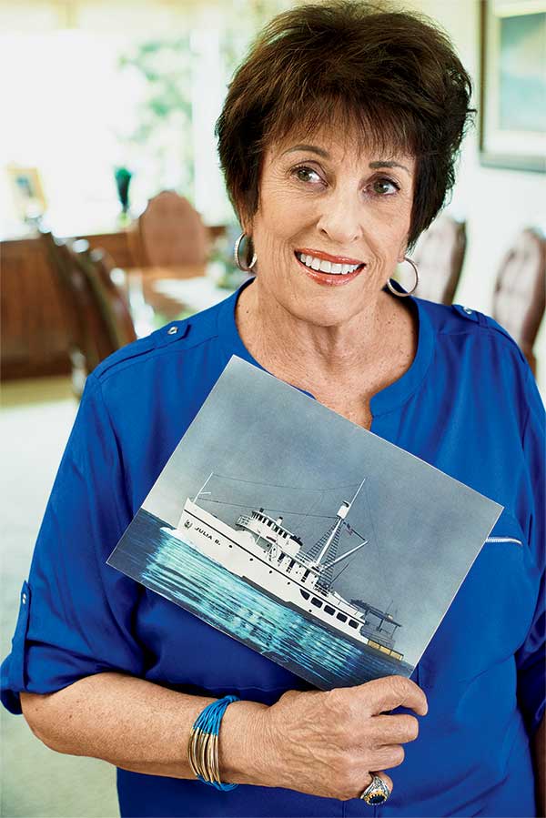 Mary, Phil's mother, holds a photo of the Julia B., Al’s fishing boat.