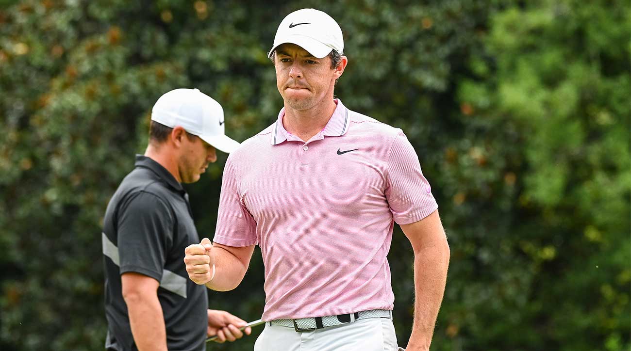 Rory McIlroy fist pumps at the Tour Championship with Brooks Koepka behind him.