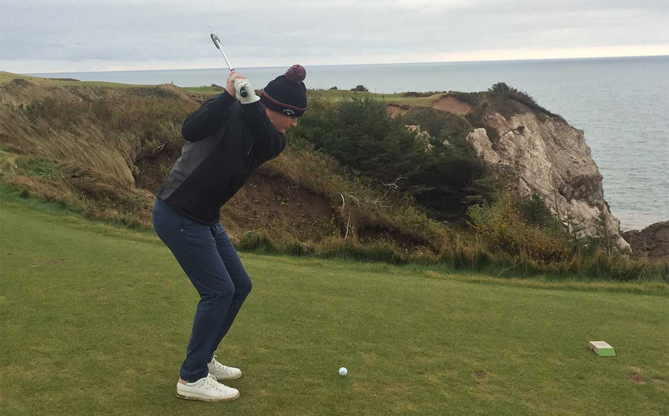 Teeing off on the par-3 16th at Cabot Cliffs.