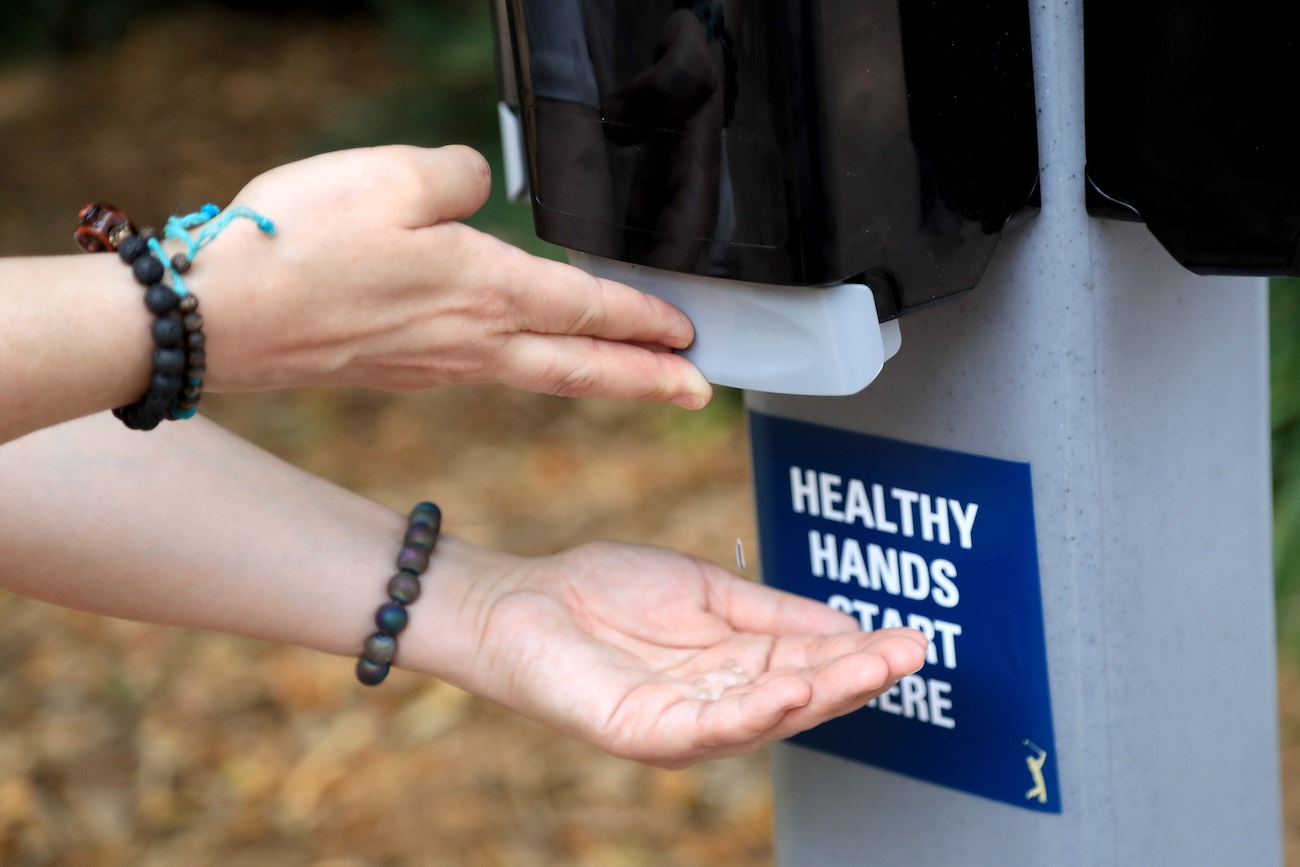 A fan uses hand sanitizer during a practice round at the Players Championship.