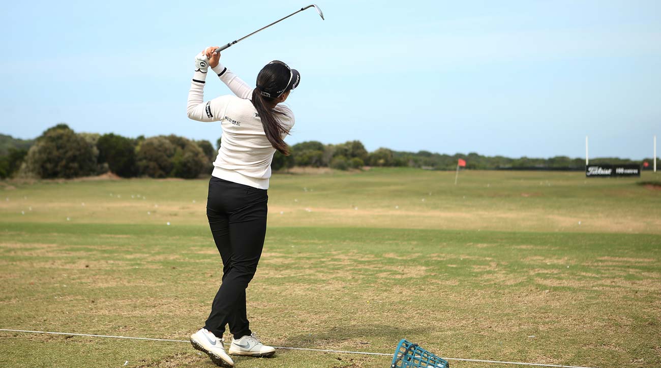 woman hitting range balls