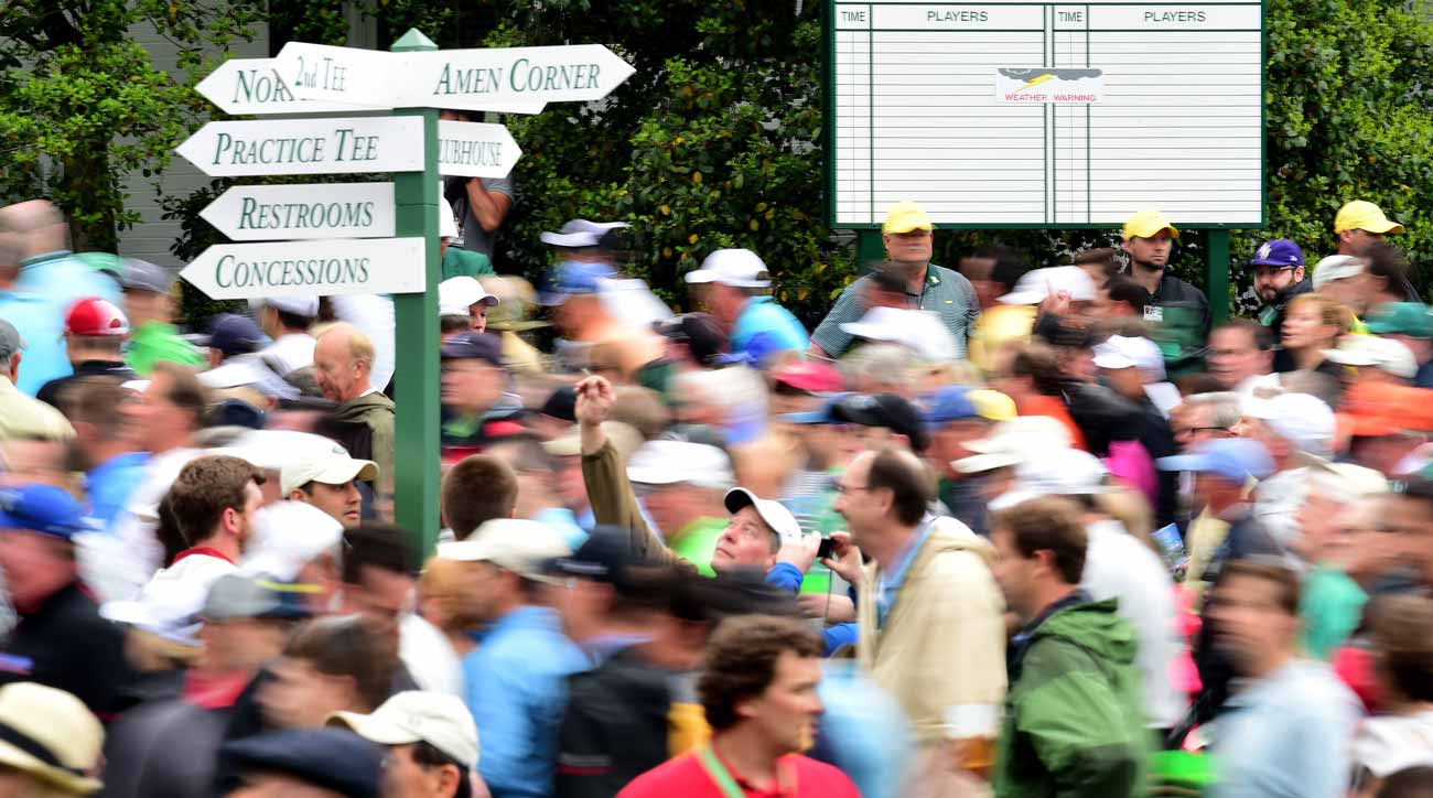 A sign pointing towards Amen Corner, awash in human activity.