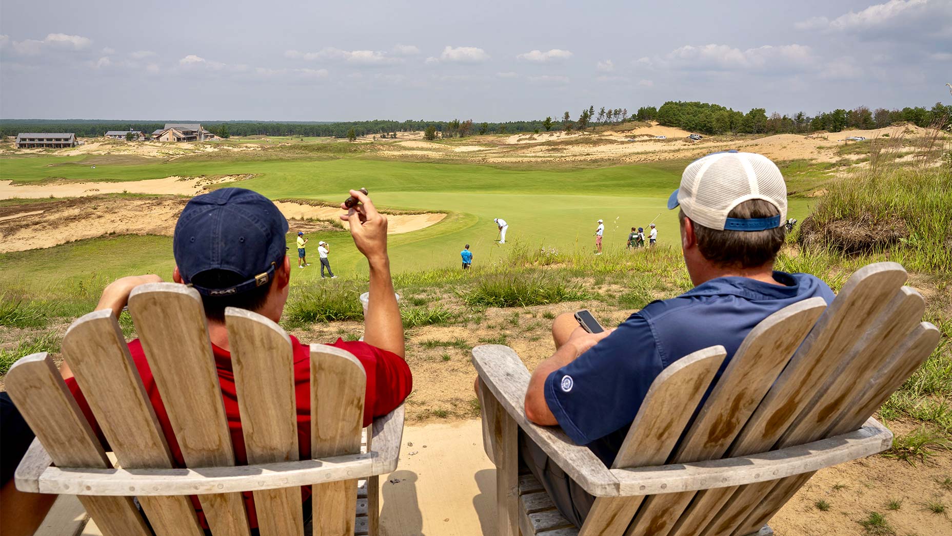 golfers look out over sand valley