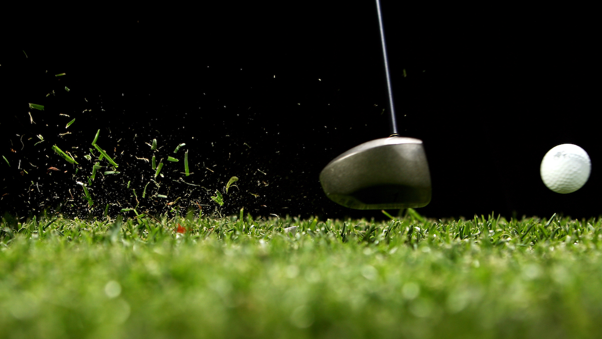 Driver hitting golf ball