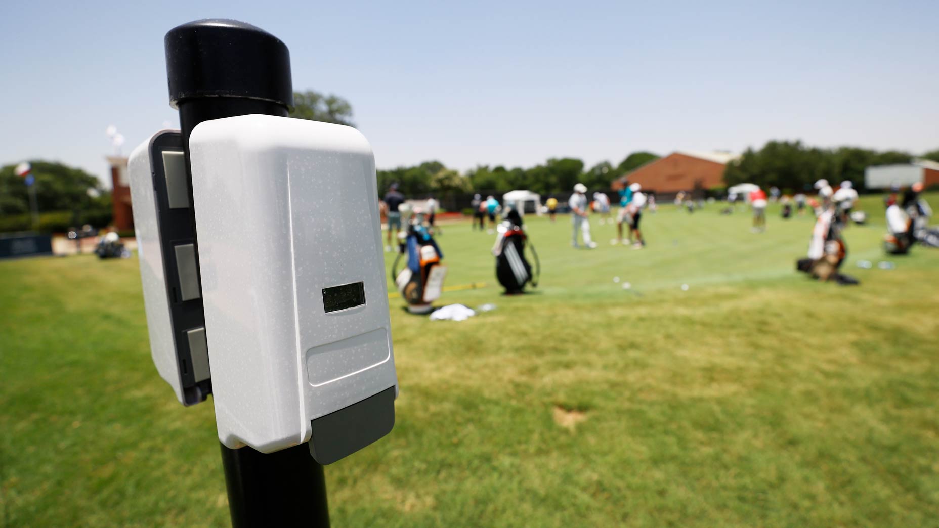 Hand sanitizer station near putting green