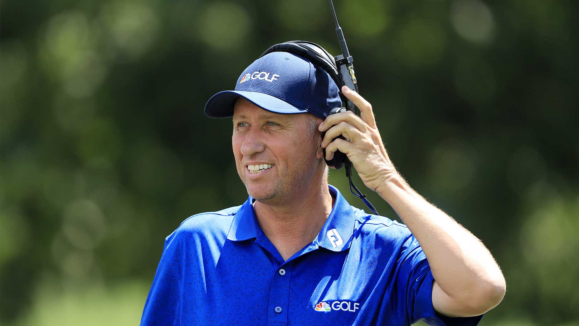 bones mackay smiles holding his headset