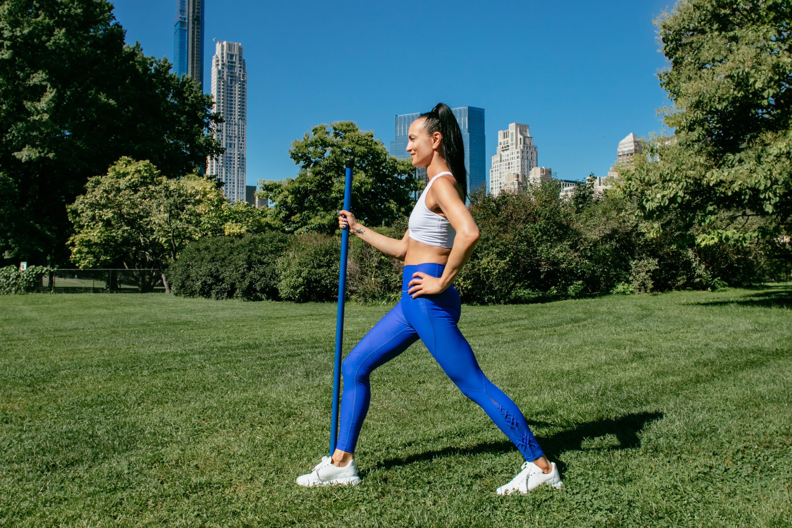 An instructor demonstrates a hamstring stretch.