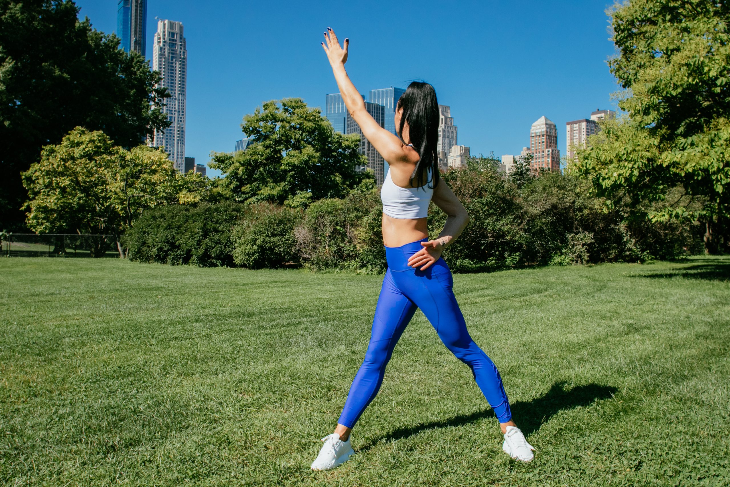 An instructor demonstrates a stretch.