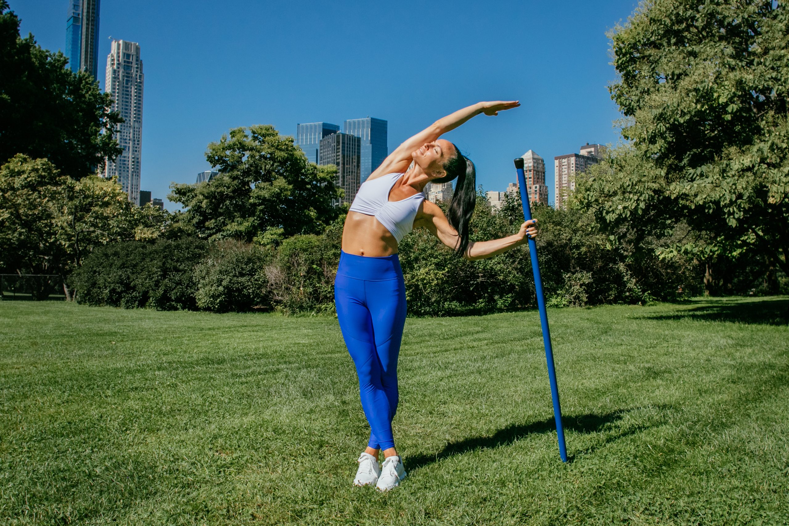 An instructor demonstrates a stretch.