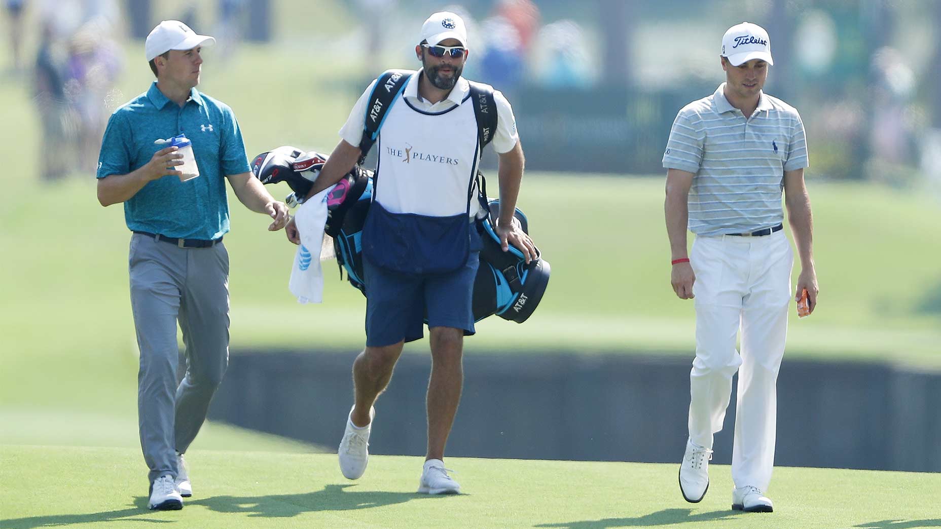 Jordan Spieth, Michael Greller and Justin Thomas walk down the fairway during the 2018 Players Championship.