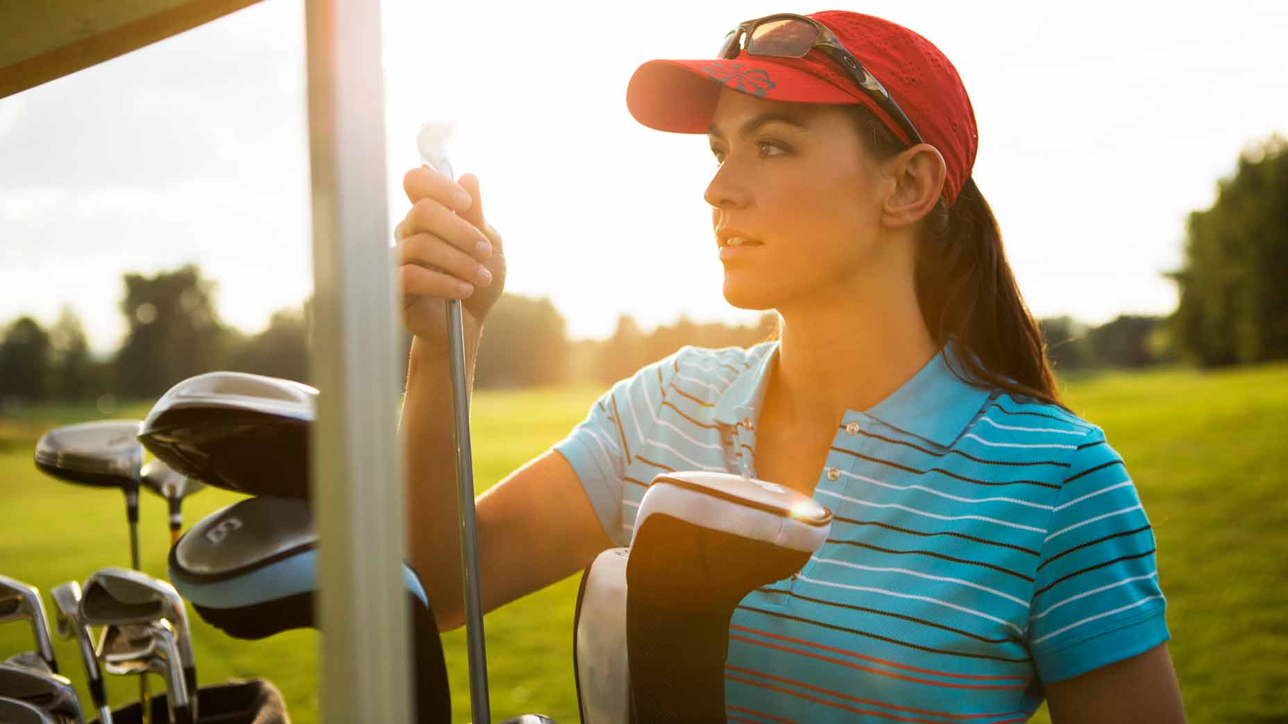 woman with golf clubs
