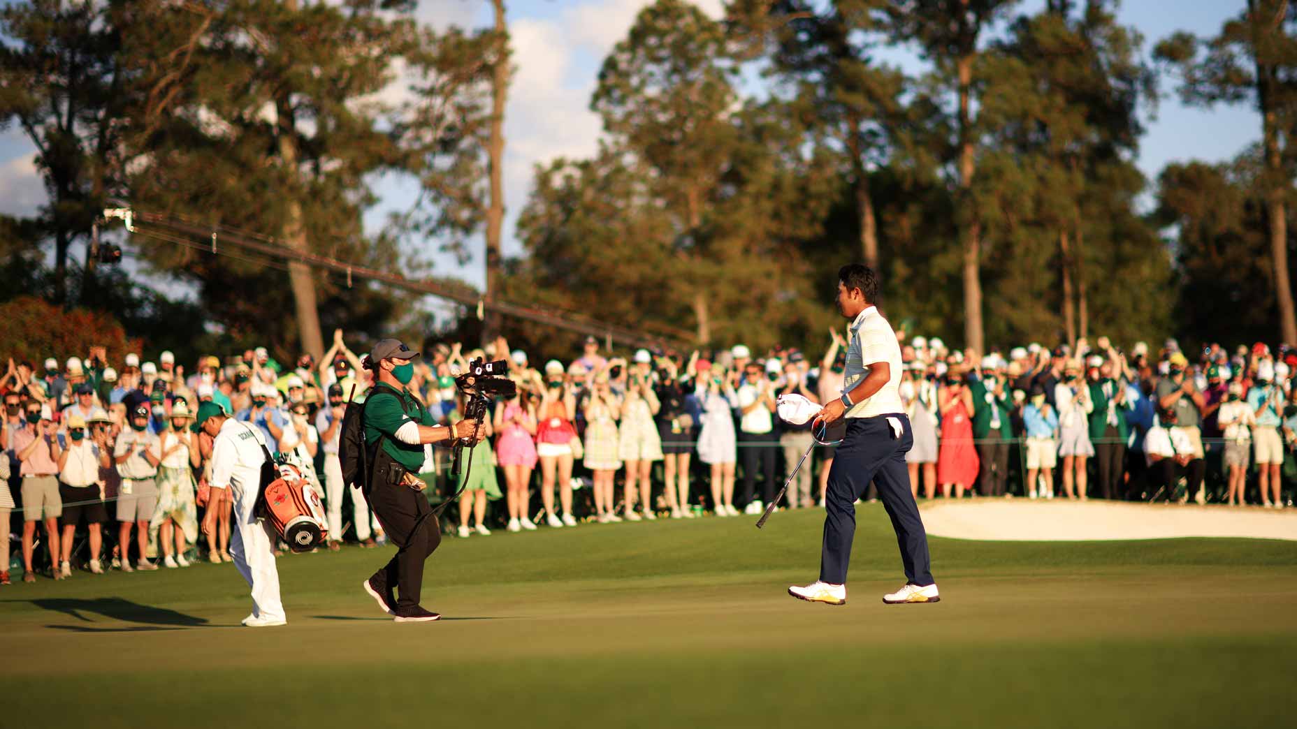 hideki matsuyama walks off the green