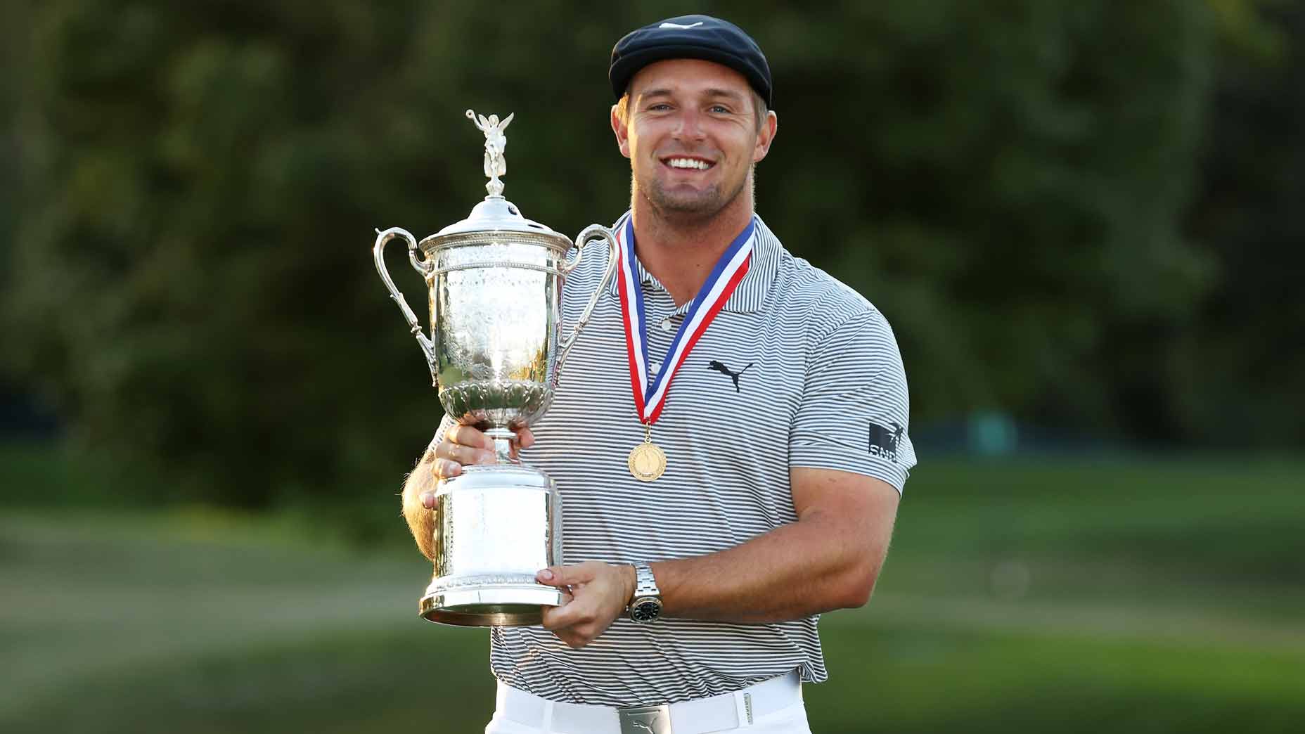 bryson dechambeau holds trophy