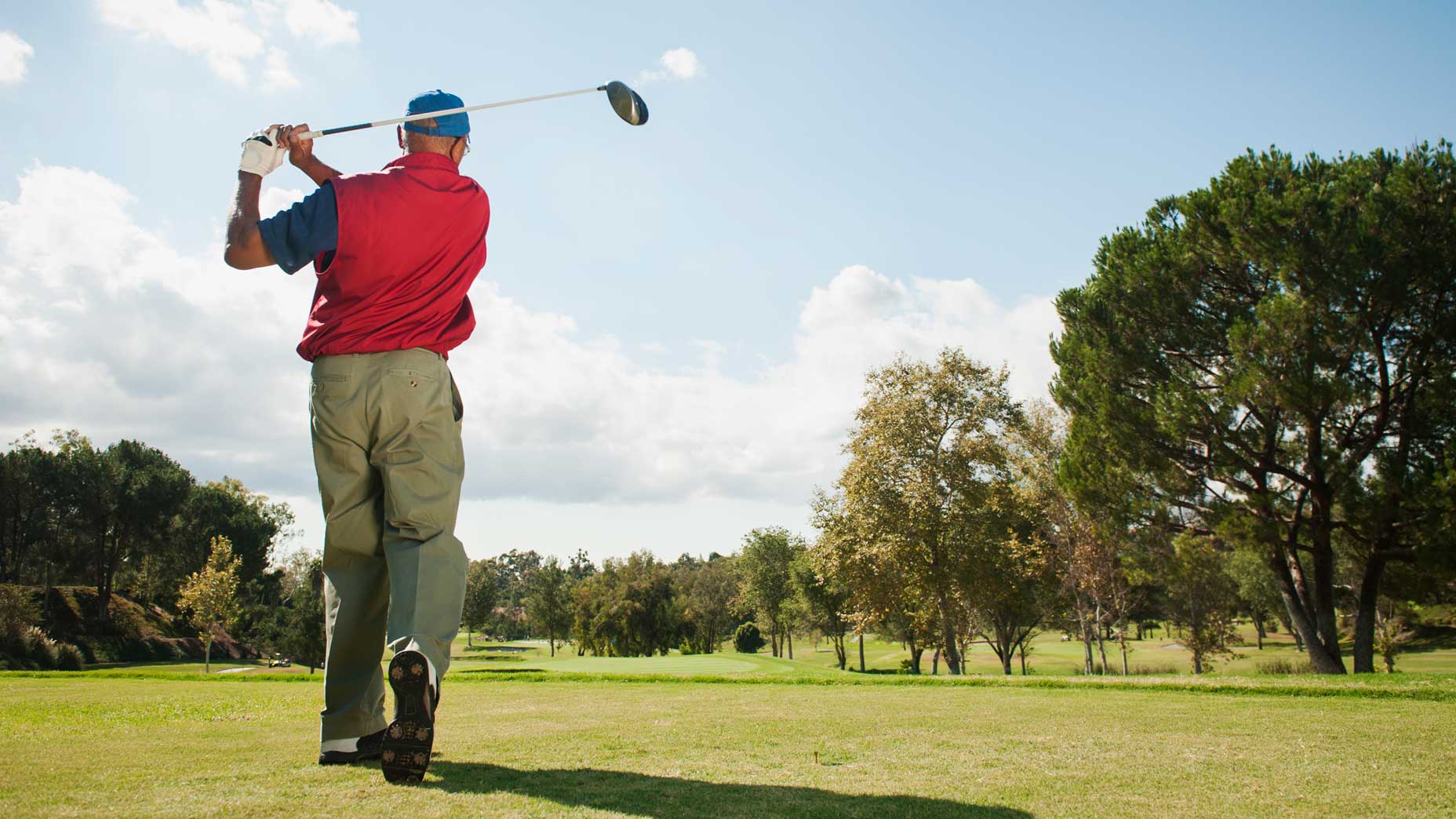 older golfer swings