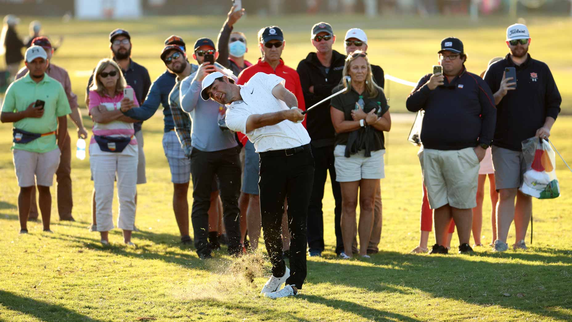 Scottie Scheffler hits a shot surrounded by fans at the 2021 Houston Open