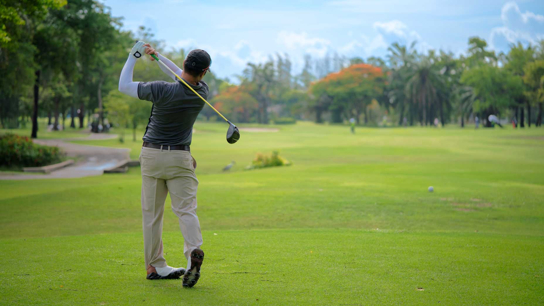 man swings club