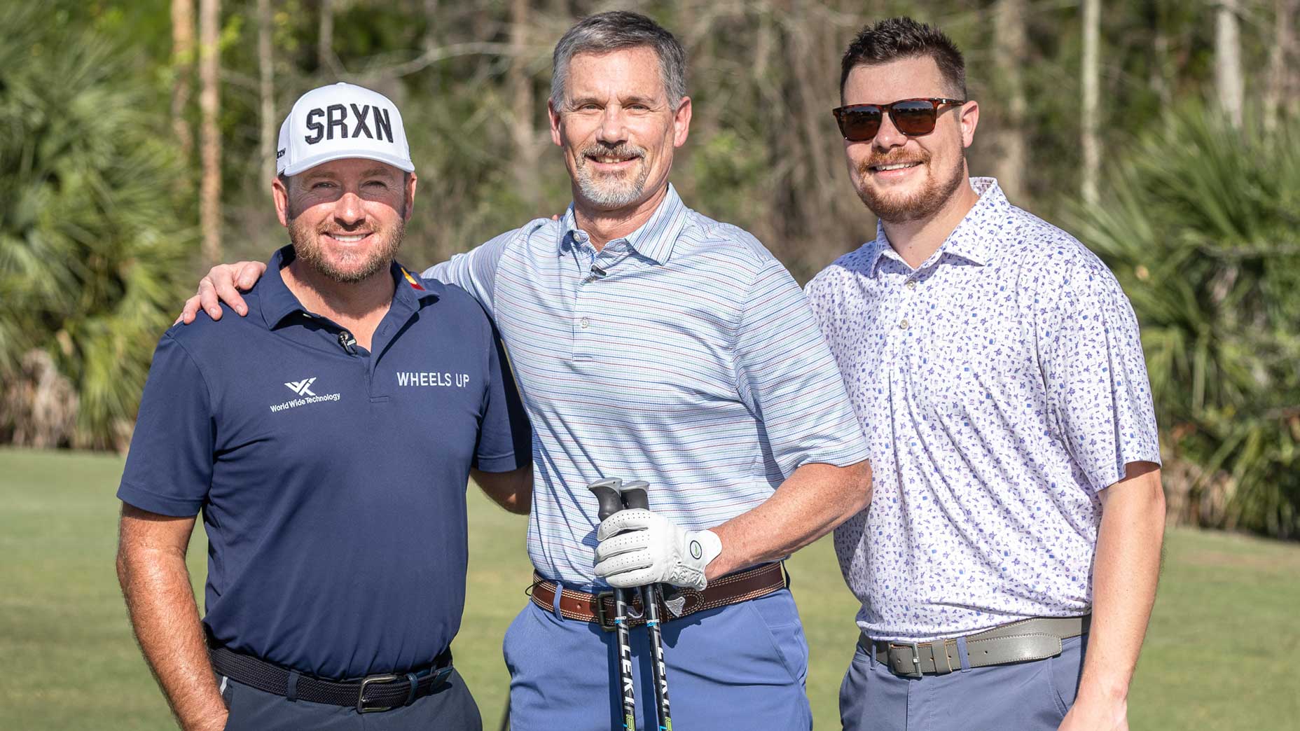 PGA Tour pro Graeme McDowell and golf fans Jared Doerfler and his dad on golf course