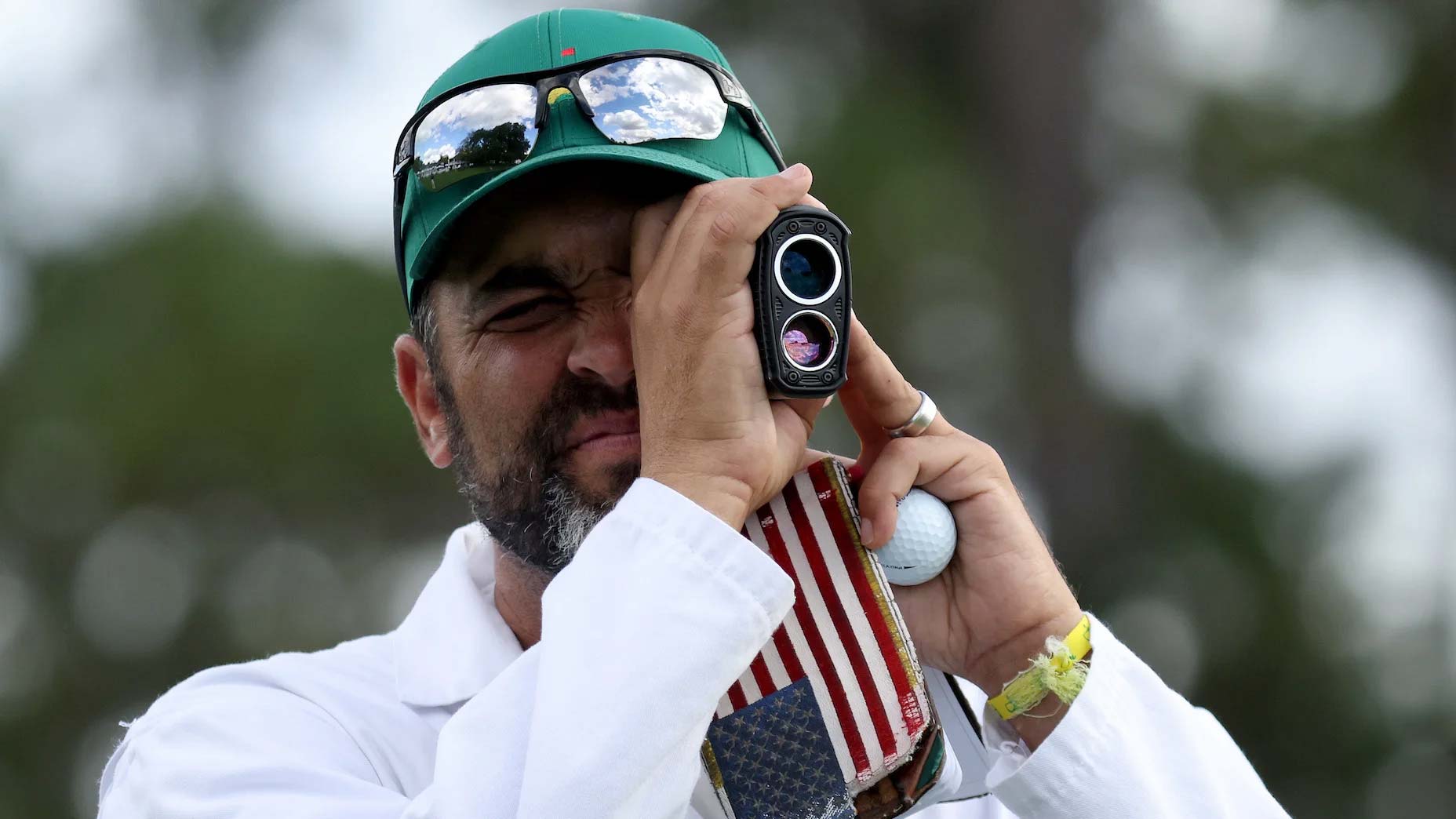 Caddie Michael Greller uses his rangefinder at Augusta National?