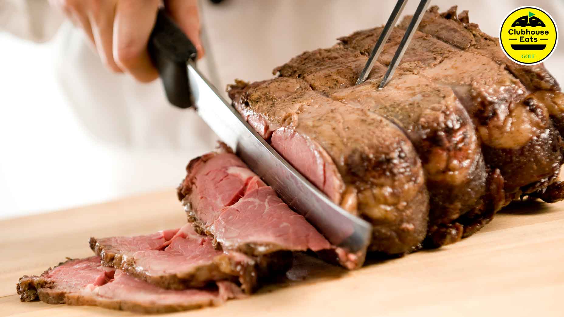 a person slices prime rib
