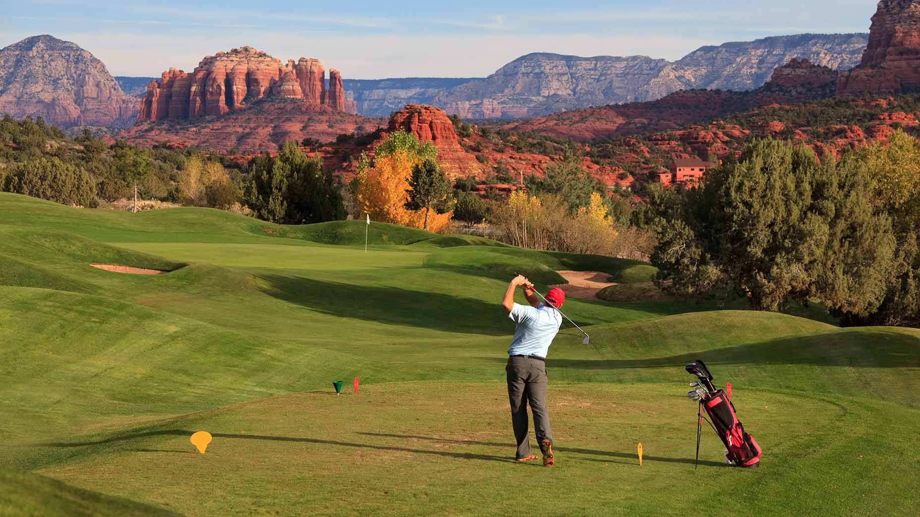 A man tees off on a golf course