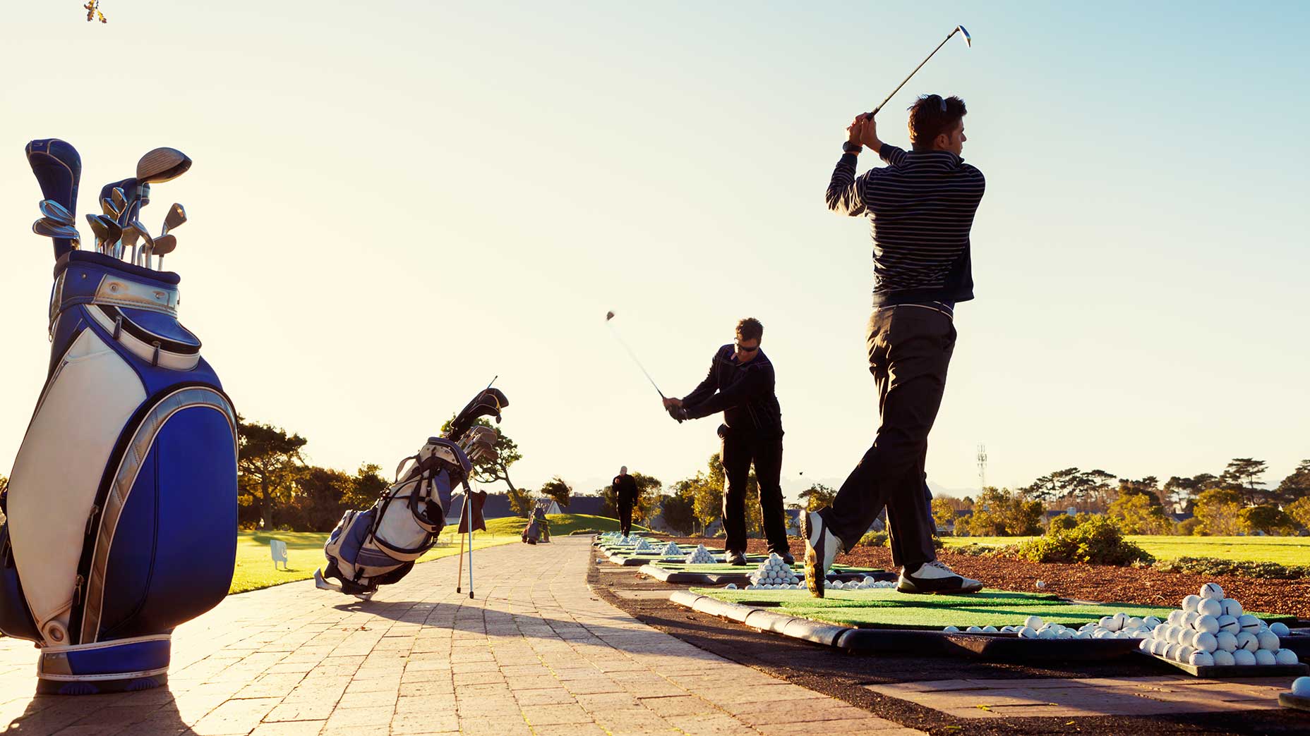 A golfer on a driving range.
