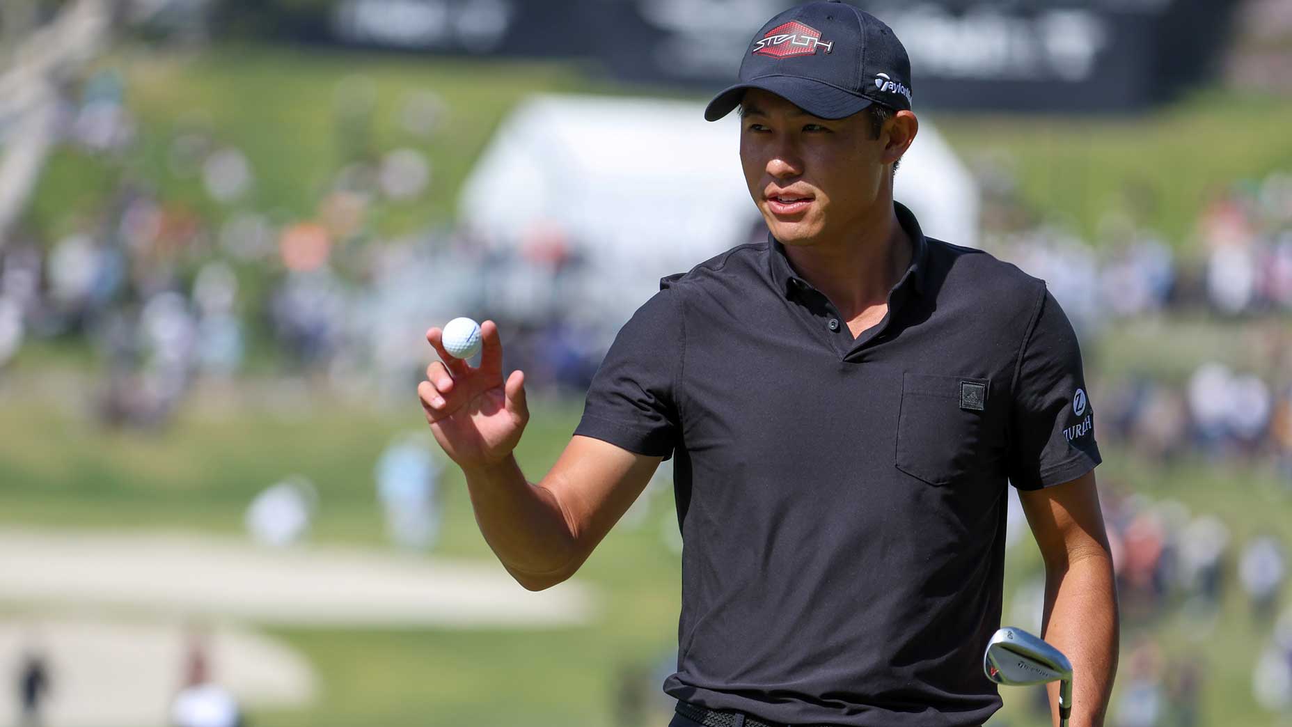 Collin Morikawa waves to crowd during 2022 Genesis Invitational