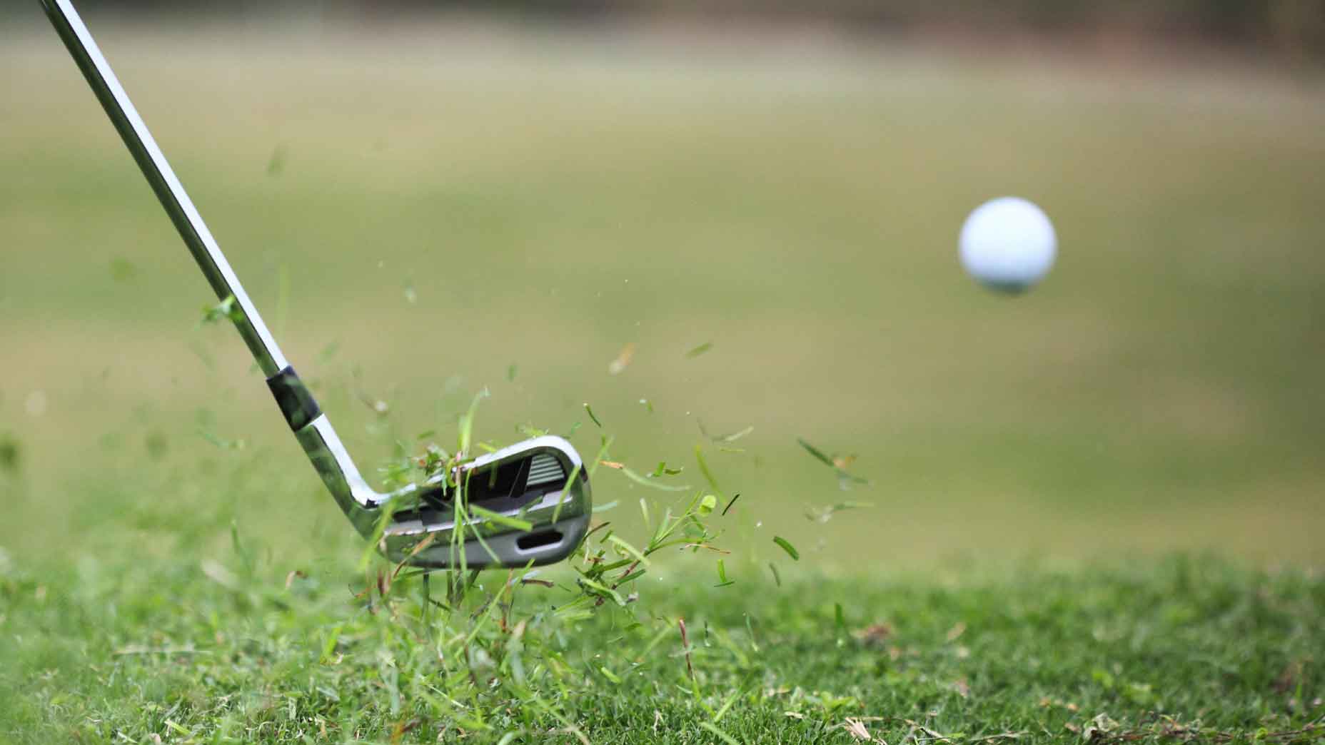 iron hits golf ball