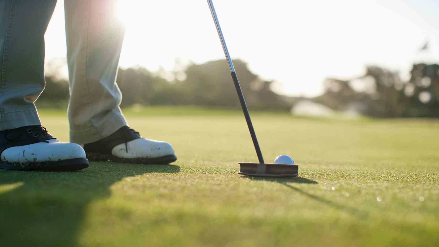 Putter at address on green