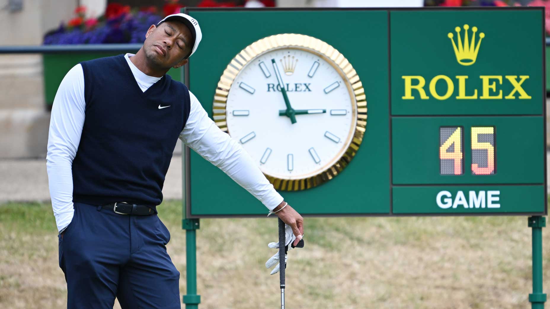 Tiger Woods stretched out during a wait on Thursday at St. Andrews' Old Course.