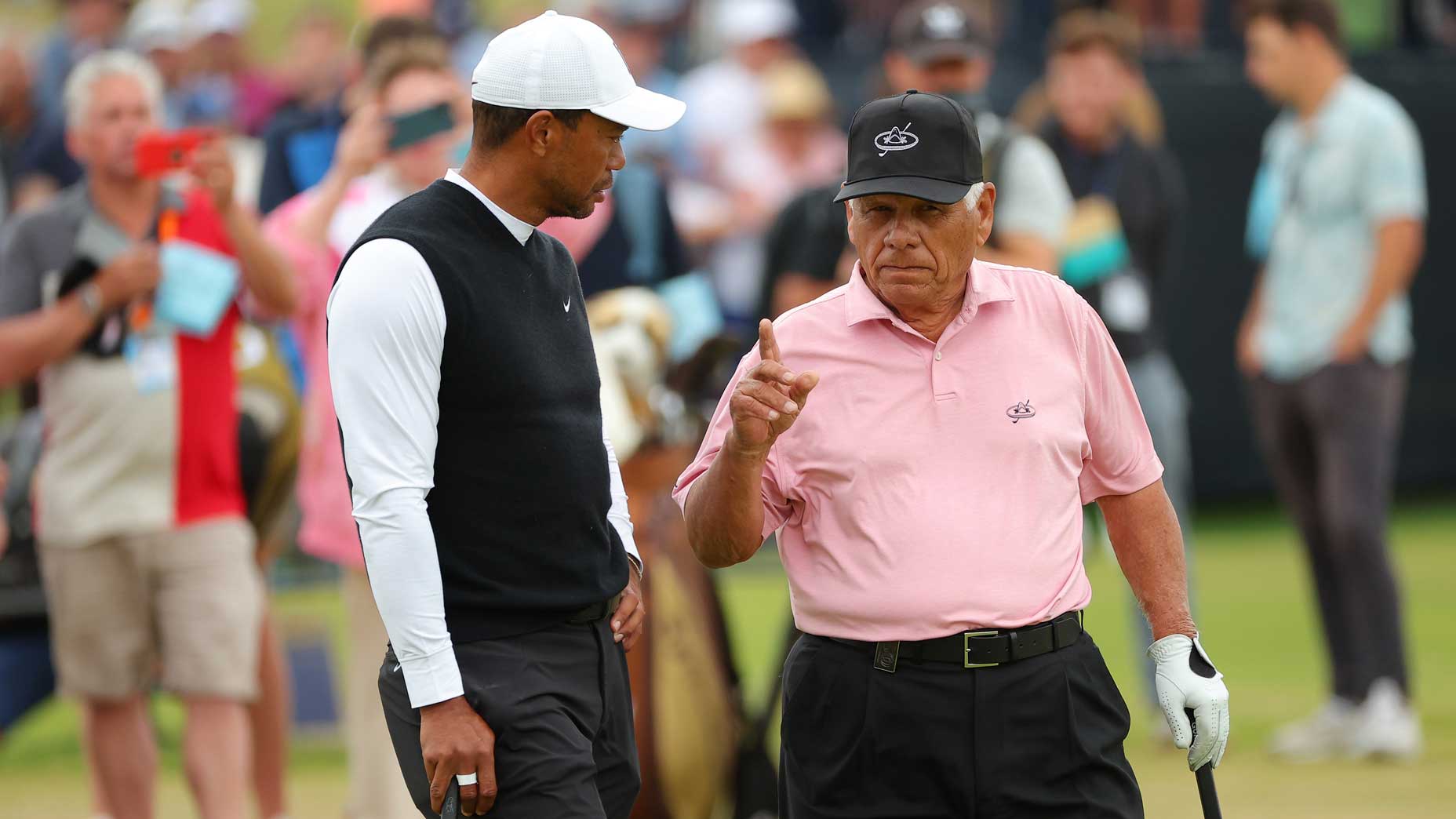 Tiger Woods and Lee Trevino talking shop at St. Andrews.