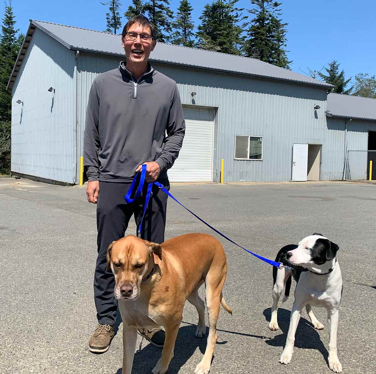 Bandon Dunes director of agronomy Ken Nice with Beau (left) and Billie.
