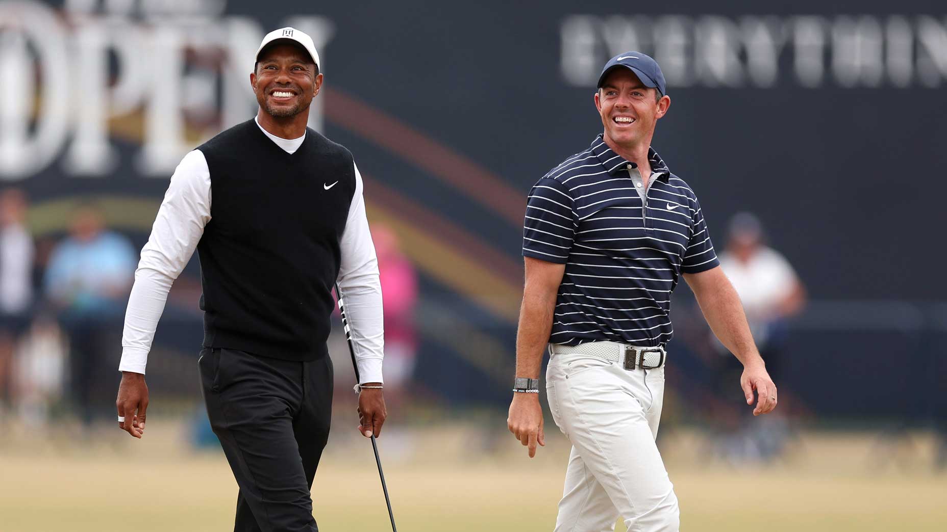Tiger Woods and Rory McIlroy smile and walk course at St. Andrews
