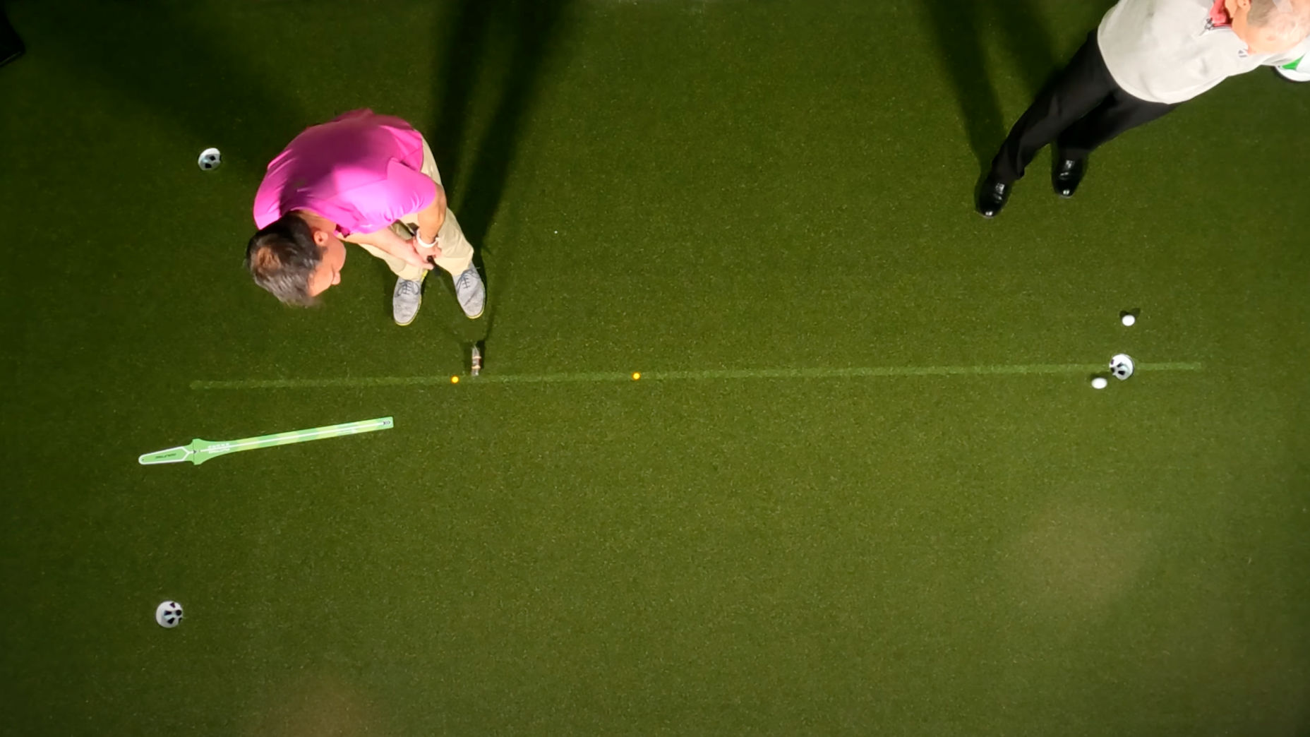 Golfer practices putting on green