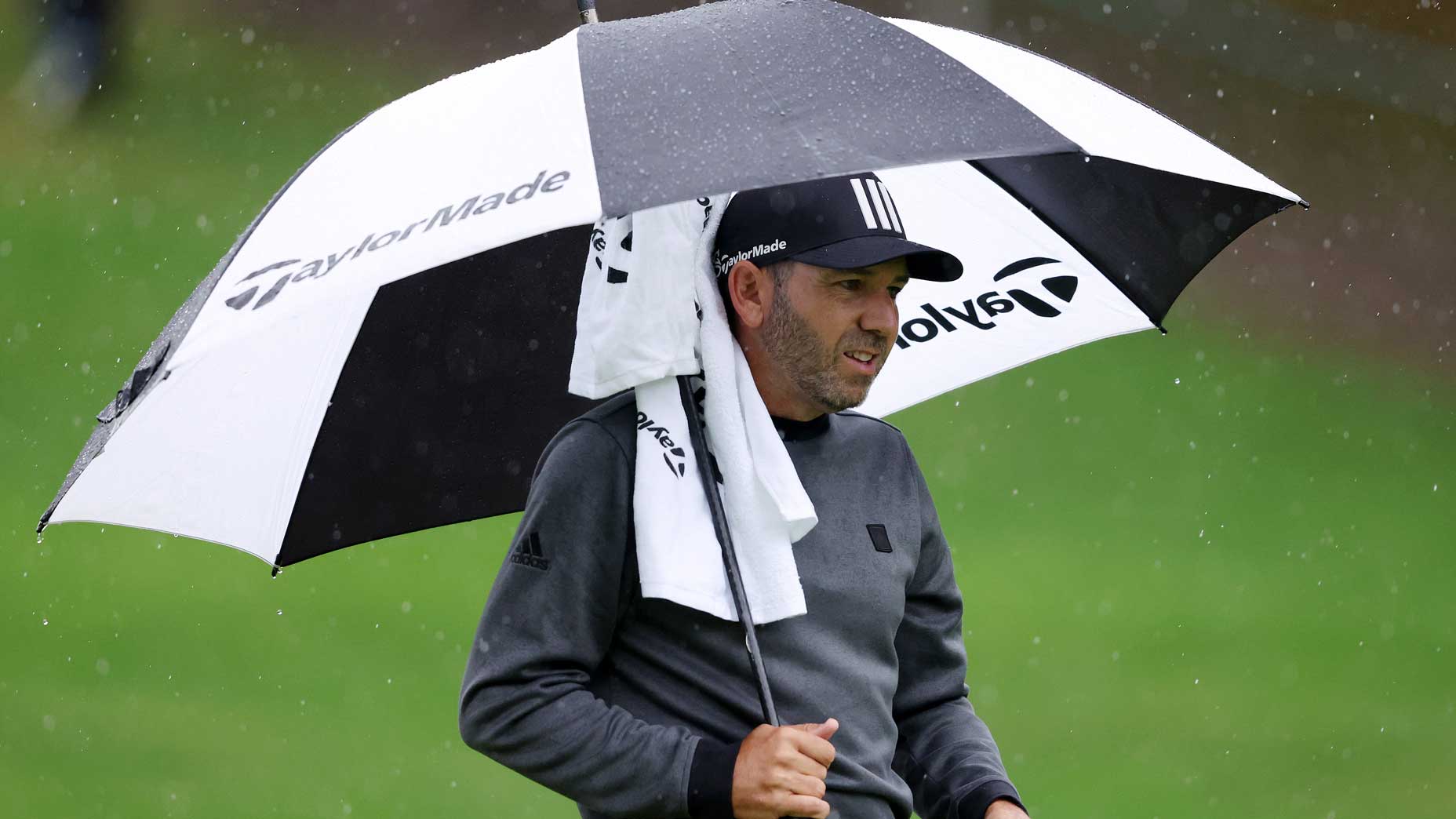 Sergio Garcia of Spain looks on from under their umbrella on the 4th hole during Day One of the BMW PGA Championship at Wentworth Golf Club on September 08, 2022 in Virginia Water, England.