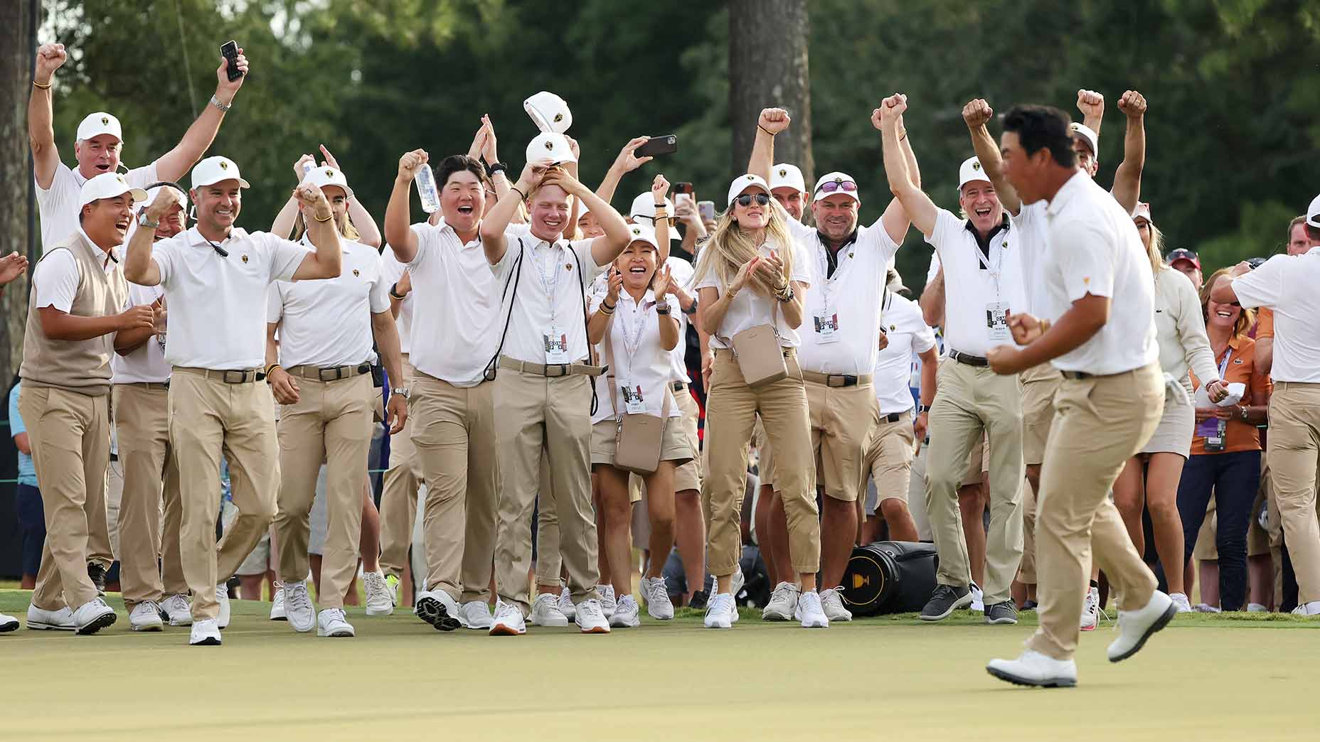 The International Presidents Cup team celebrates Tom Kim's match-winning putt on Saturday.