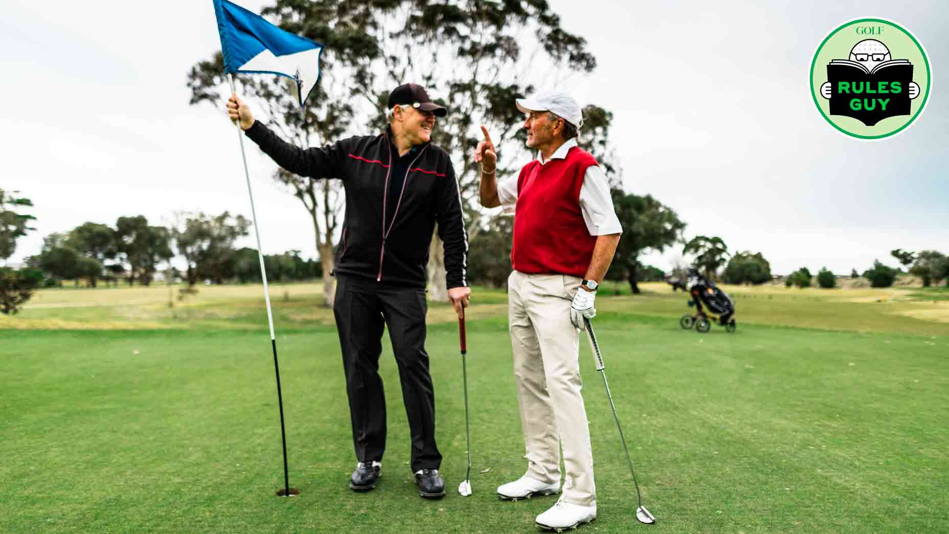 golfers holding flagstick on green