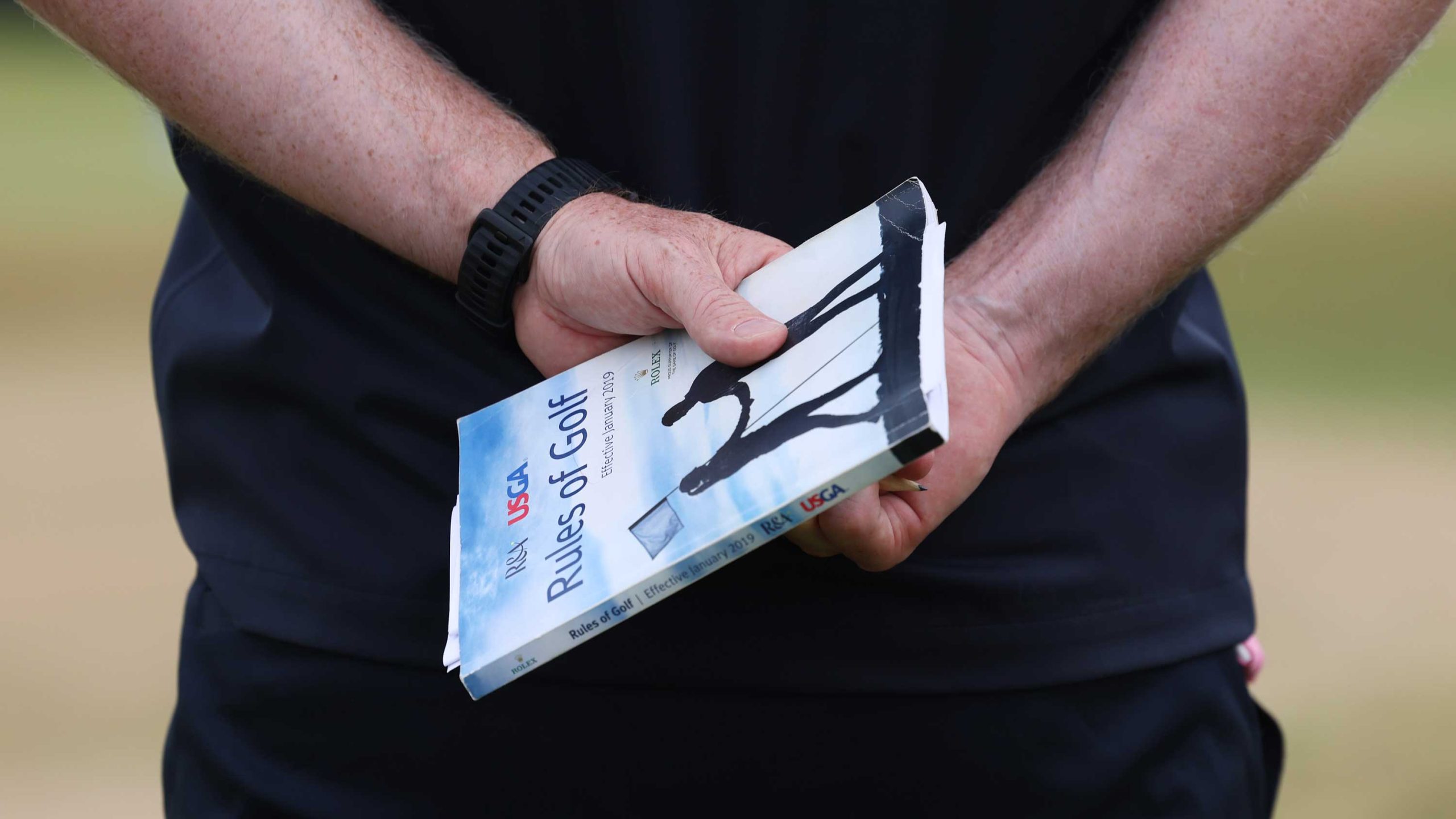 official with rules of golf