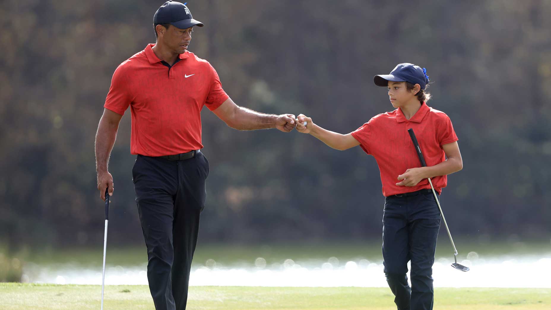 tiger and charlie woods fist bump