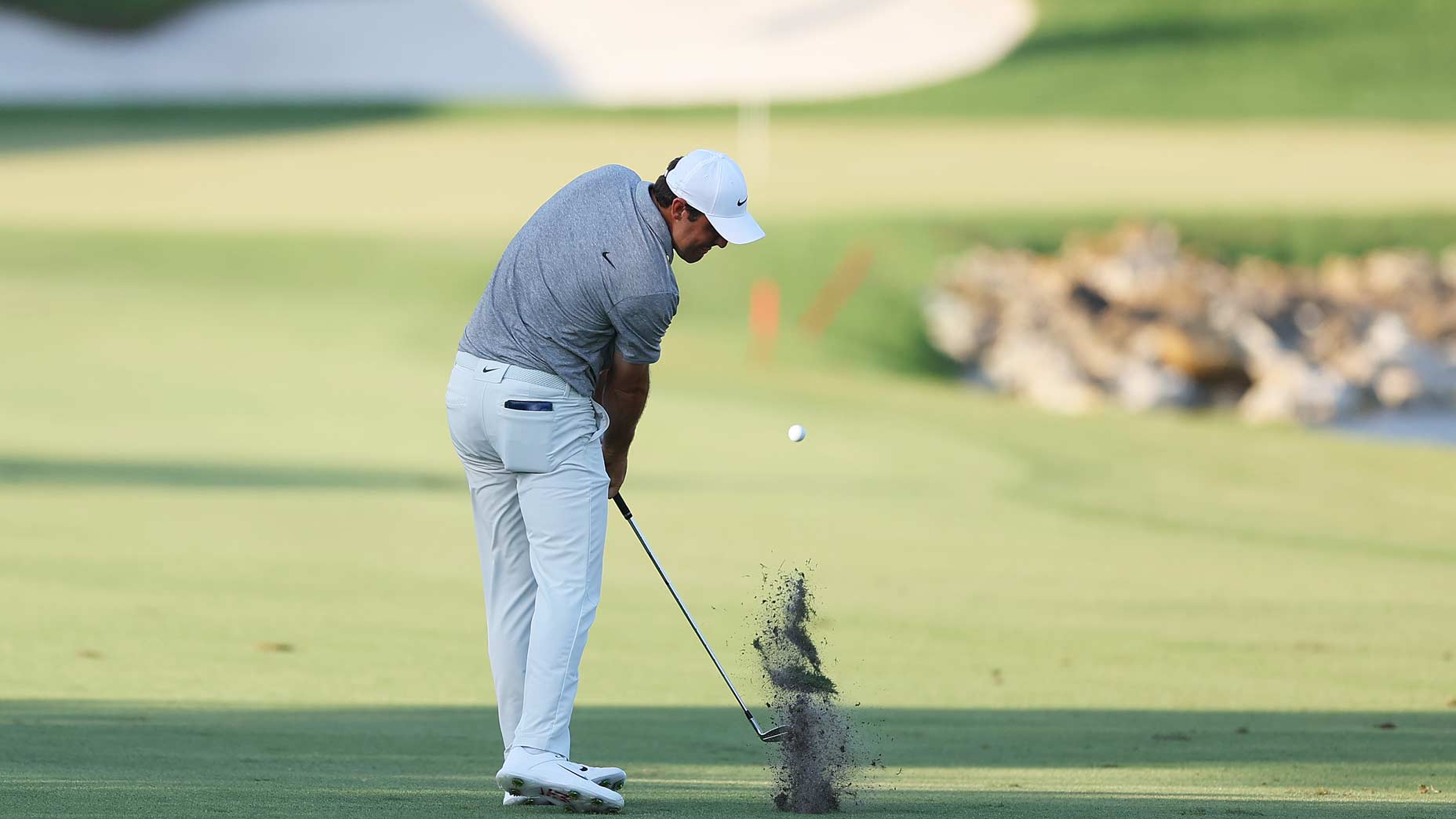 Scottie Scheffler of the United States plays a shot on the 18th hole during the third round of the Arnold Palmer Invitational presented by Mastercard at Arnold Palmer Bay Hill Golf Course on March 04, 2023 in Orlando, Florida.