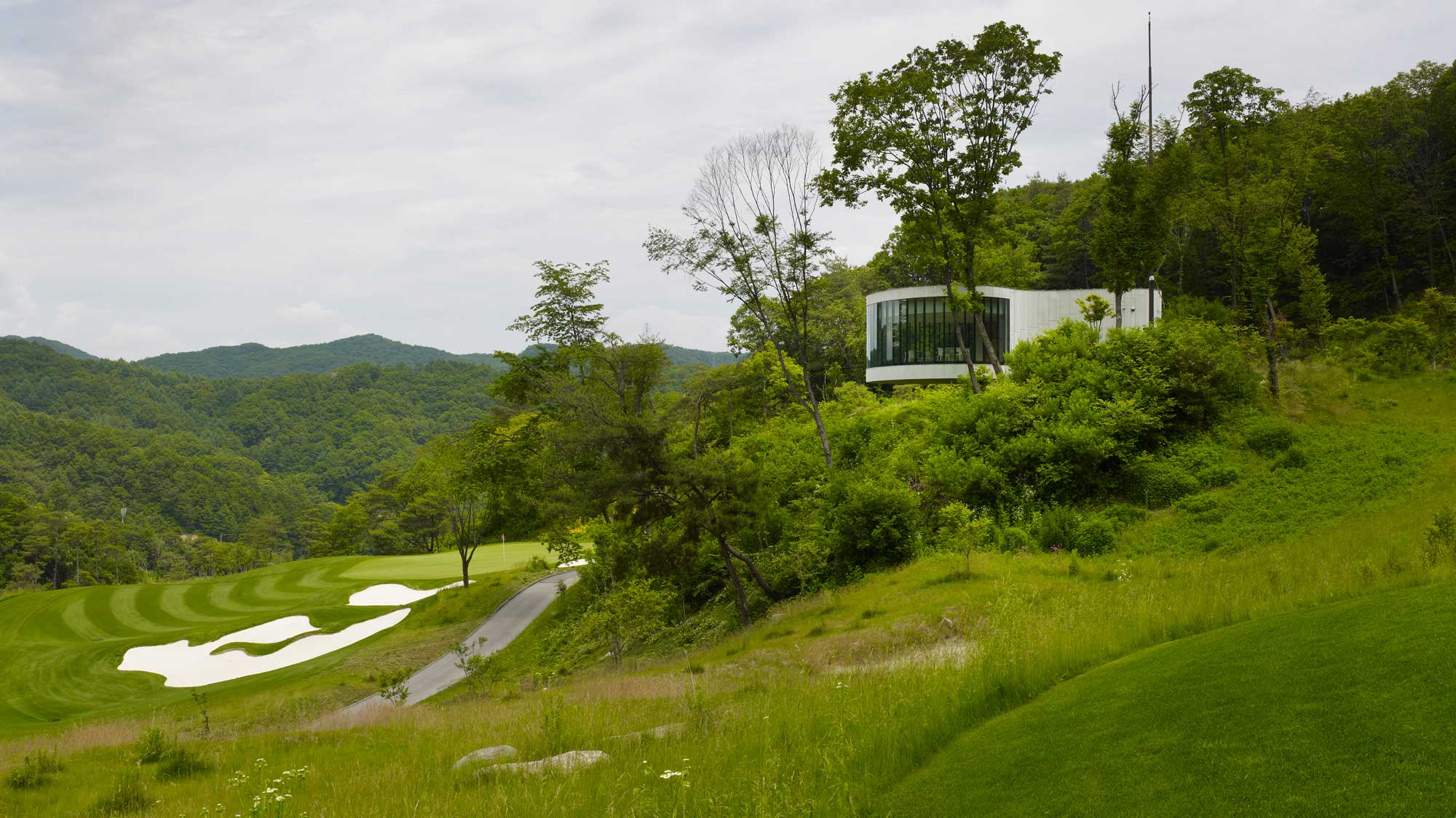 Whistling Rock Golf Clubhouse, Chuncheon, Korea, South. Architect: Mecanoo, 2012. Tea house on golf course slope.