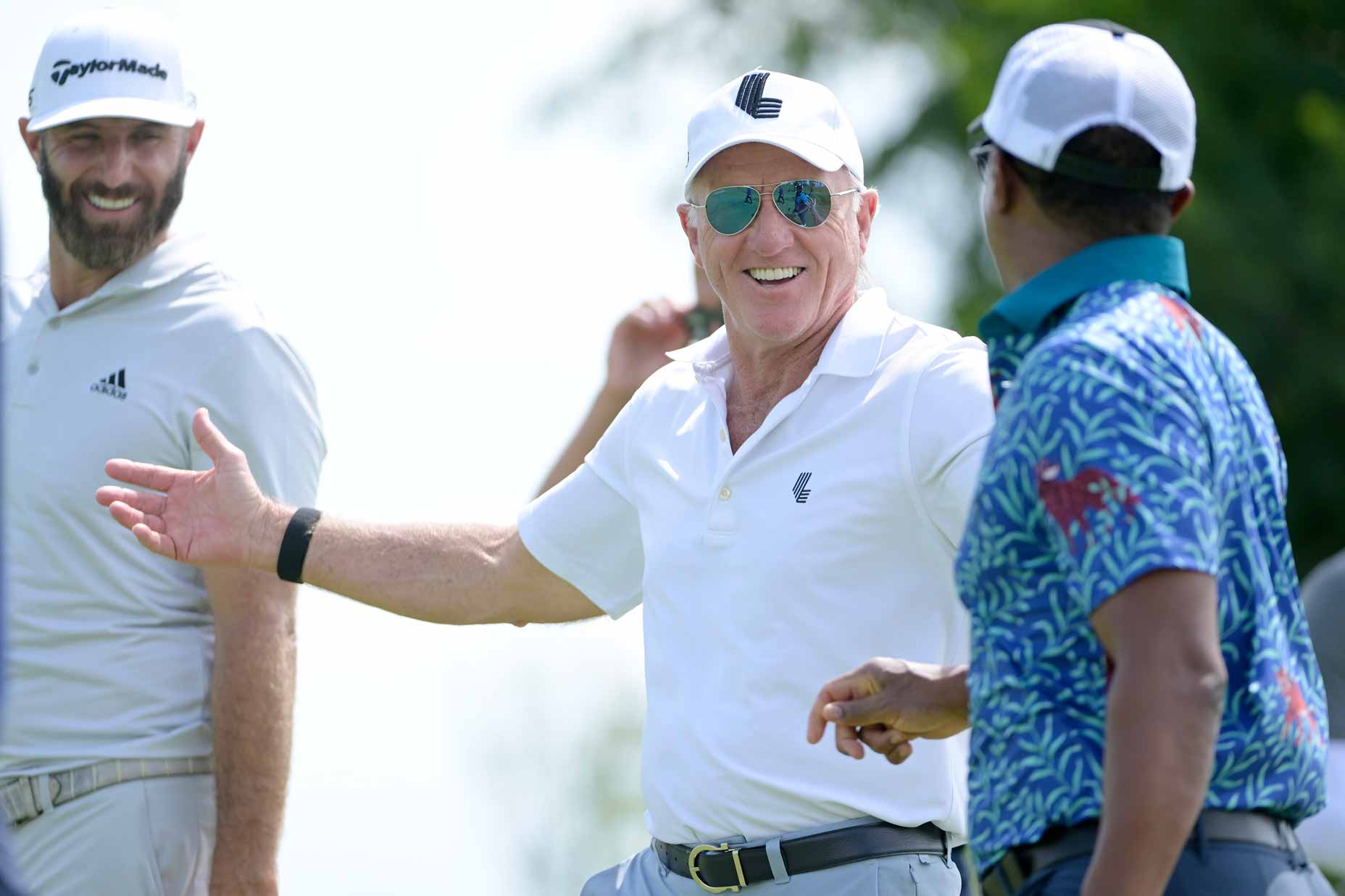 Team Captain Dustin Johnson of 4 Aces GC, Greg Norman, CEO and commissioner of LIV Golf, and Majed Al Sorour, CEO of Saudi Golf Federation, talk on the 14th hole during the pro-am prior to the LIV Golf Invitational - Bangkok at Stonehill Golf Course on October 06, 2022 in Pathum Thani, Thailand.