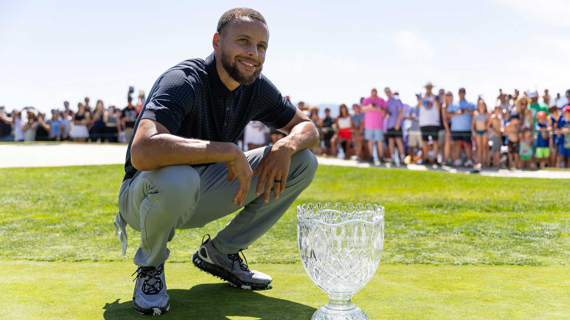 stephen curry poses with american century trophy