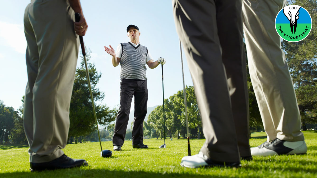 golfer talking on first tee with foursome