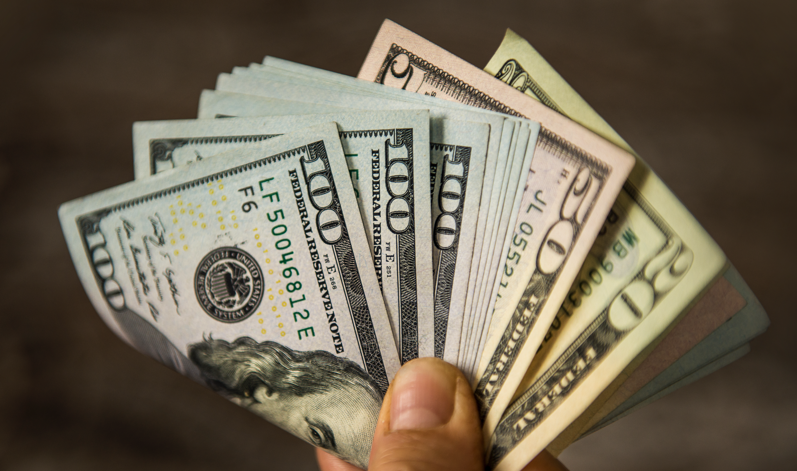 hand holding bunch of money