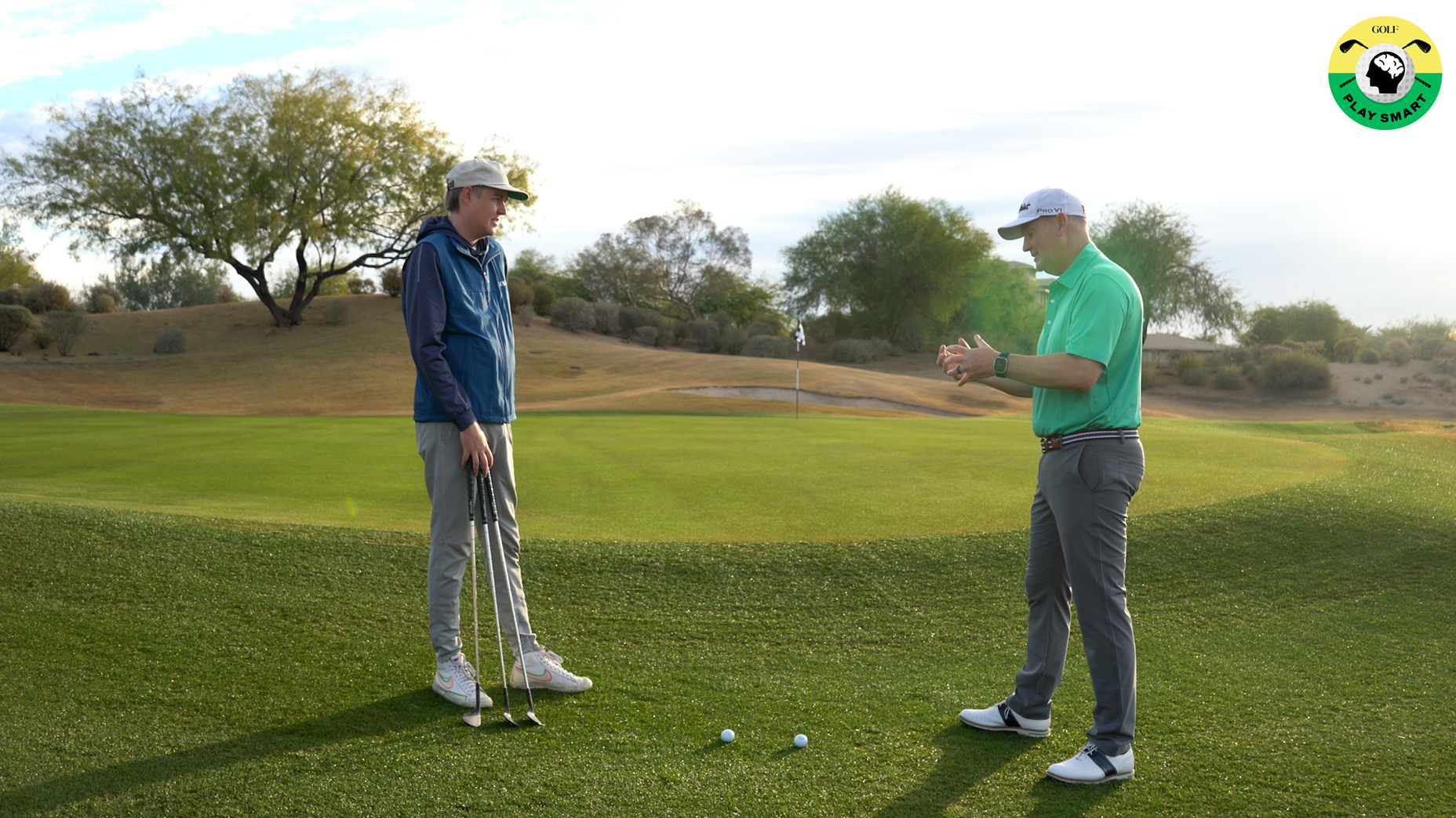 jon tattersall talks to zephyr melton next to a putting green