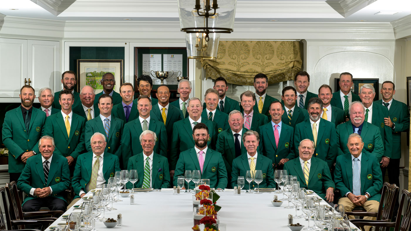 Past Masters champions pose with Jon Rahm in green jackets at the 2024 Masters Champions Dinner