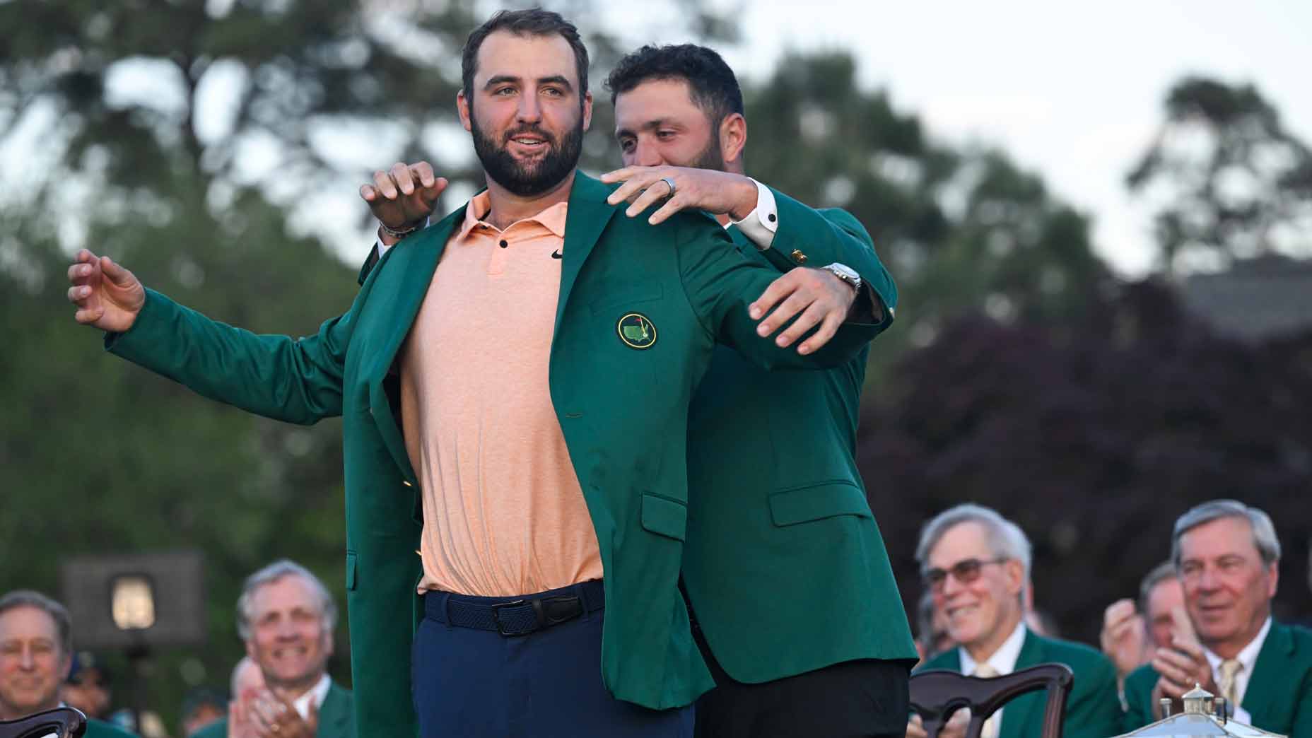 jon rahm puts the green jacket on scottie scheffler after winning the 2024 masters at augusta national