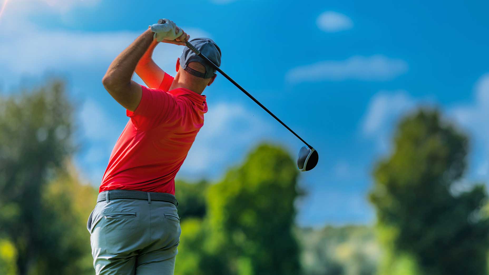 a golfer swings a golf club